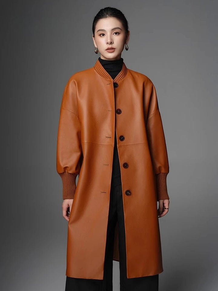 Women’s orange button-front woven coat with stand collar, patch pockets, and ribbed cuffs