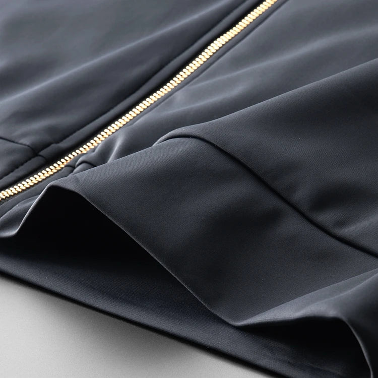 Navy two-piece hoodie top with gold zipper and angled sleeve seam