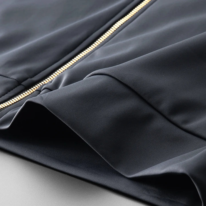 Navy two-piece hoodie top with gold zipper and angled sleeve seam