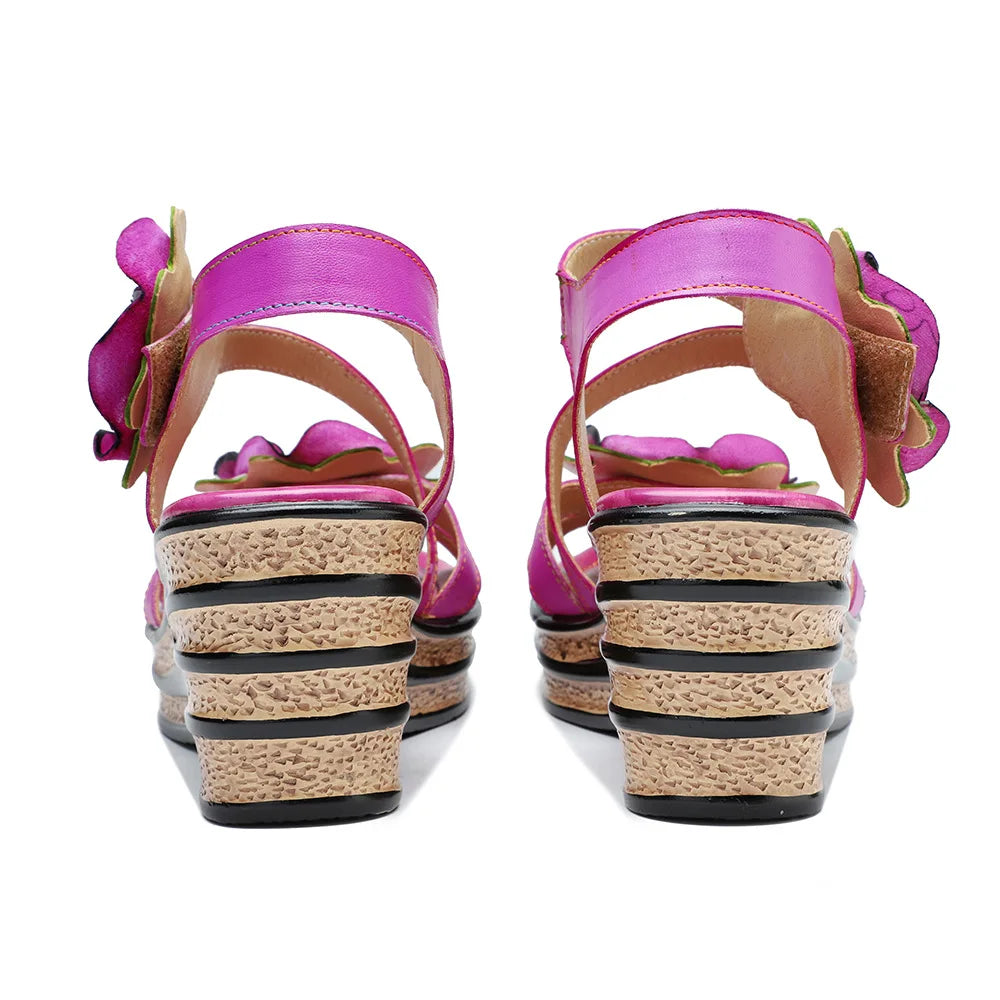 Women’s pink leather wedge sandals, rear view, with rose flowers on heel straps