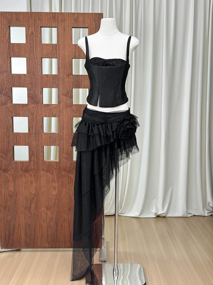 Black corset-style top and asymmetrical black tulle maxi skirt with layered ruffles