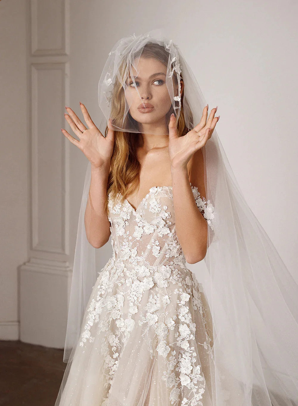 Off-shoulder lace bridal gown with sheer veil