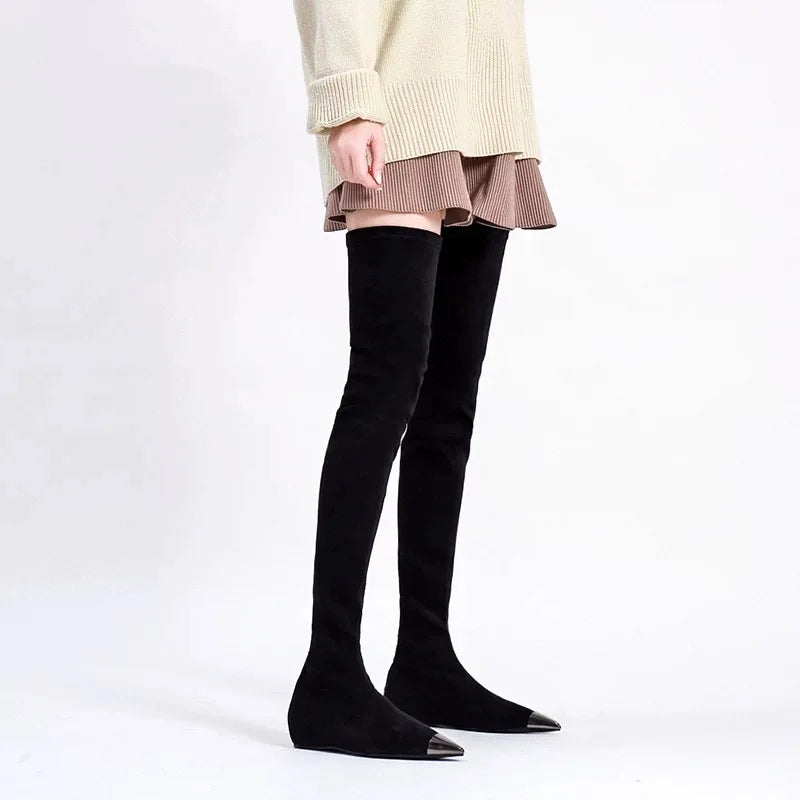 Black thigh-high faux suede boots with pointed toe and sleek fit.