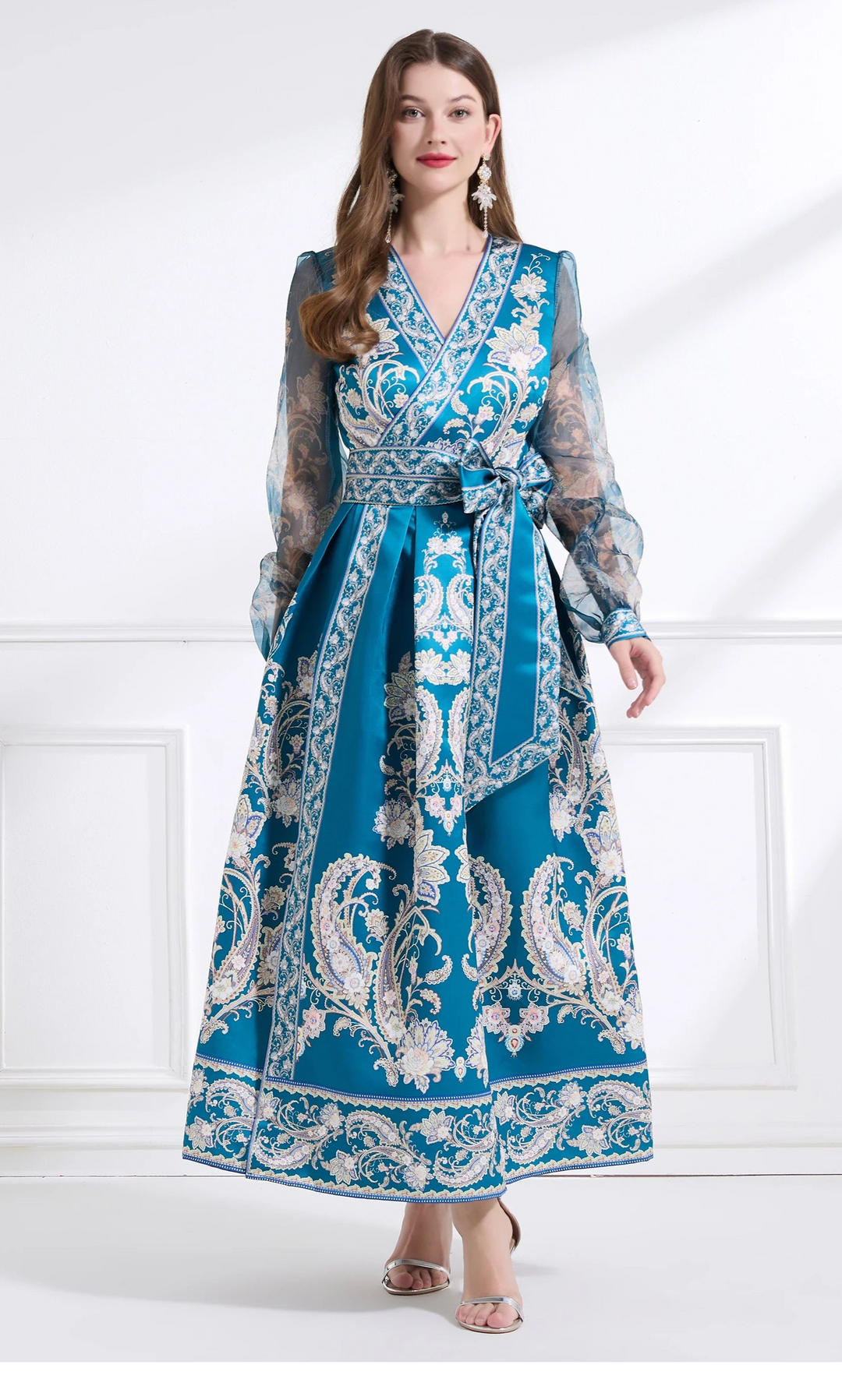 Woman wearing a blue patterned dress on a white background