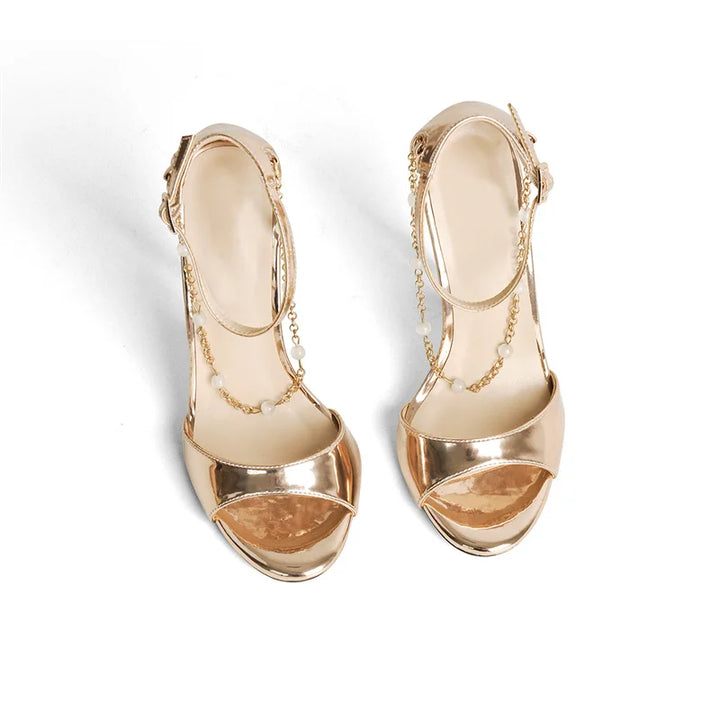 Pair of metallic gold open-toe high-heel sandals with pearl-bead chain ankle straps
