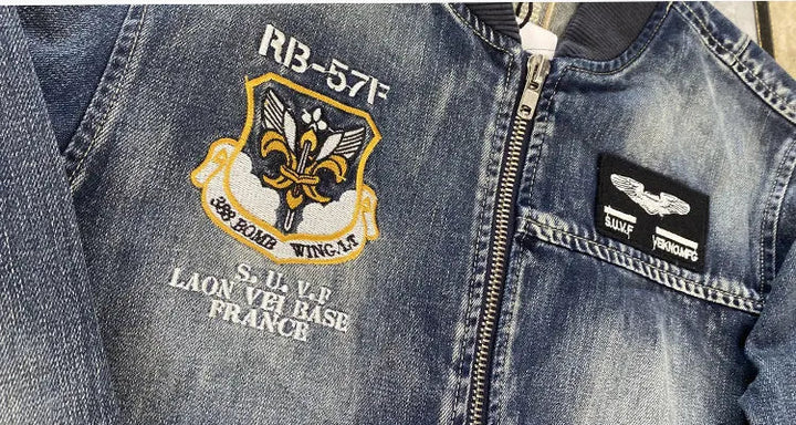 Blue denim zip-up jacket close-up of left chest crest embroidery and zipper