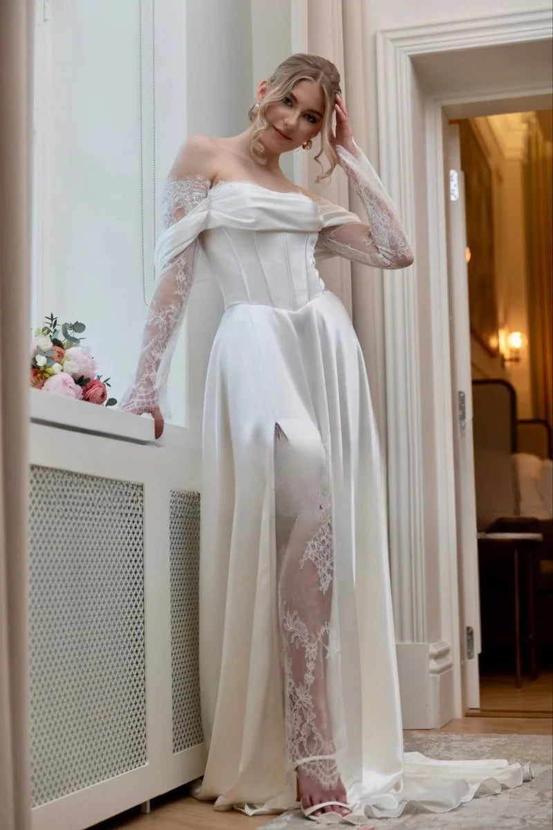 Ivory bridal gown with off-shoulder bodice, sheer lace sleeves, flowing A-line skirt