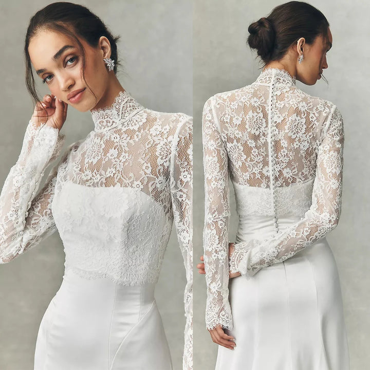 White lace bridal jacket with high neck and long sleeves, floral texture over fitted bodice