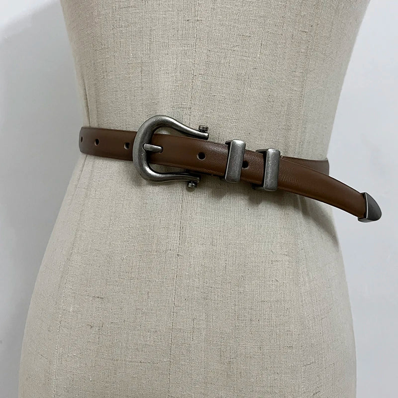 Brown narrow leather corset belt with silver-tone oval buckle and two rectangular tabs