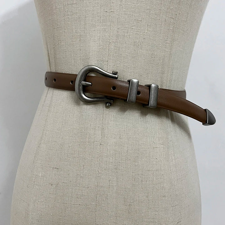 Brown narrow leather corset belt with silver-tone oval buckle and two rectangular tabs