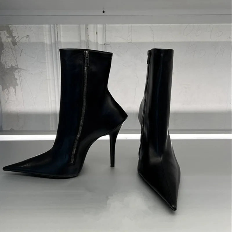 Black high heel ankle boots with pointed toe and side zipper, curved silhouette