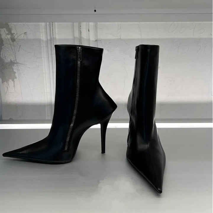 Black high heel ankle boots with pointed toe and side zipper, curved silhouette