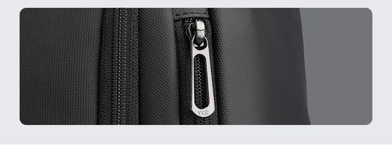 Black Oxford fabric laptop backpack with front brand plate and YKK-style zipper