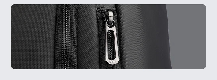 Black Oxford fabric laptop backpack with front brand plate and YKK-style zipper