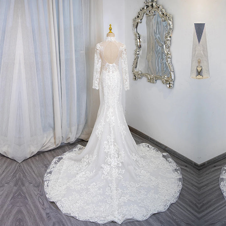 Ivory lace long-sleeve bridal gown with high neck, open-back style and dramatic train