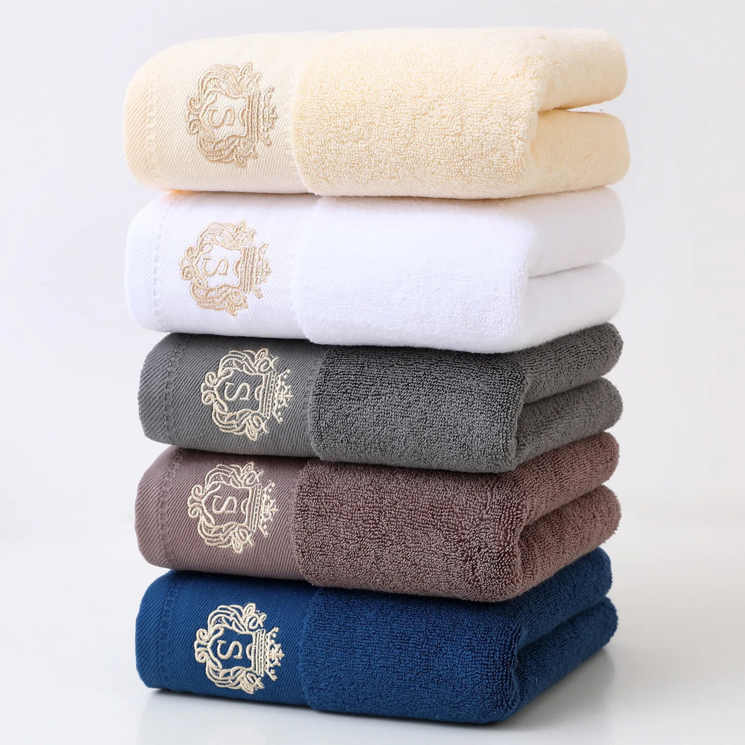 Mixed-color 5-piece bathroom towel set with gold embroidered monograms, folded stack