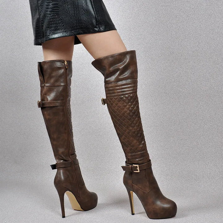 Brown over-the-knee boots with quilted upper and buckled ankle strap, stiletto heel.