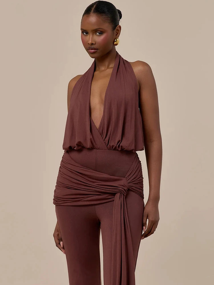 Brown halter backless jumpsuit with deep V neckline and ruched waist, front view