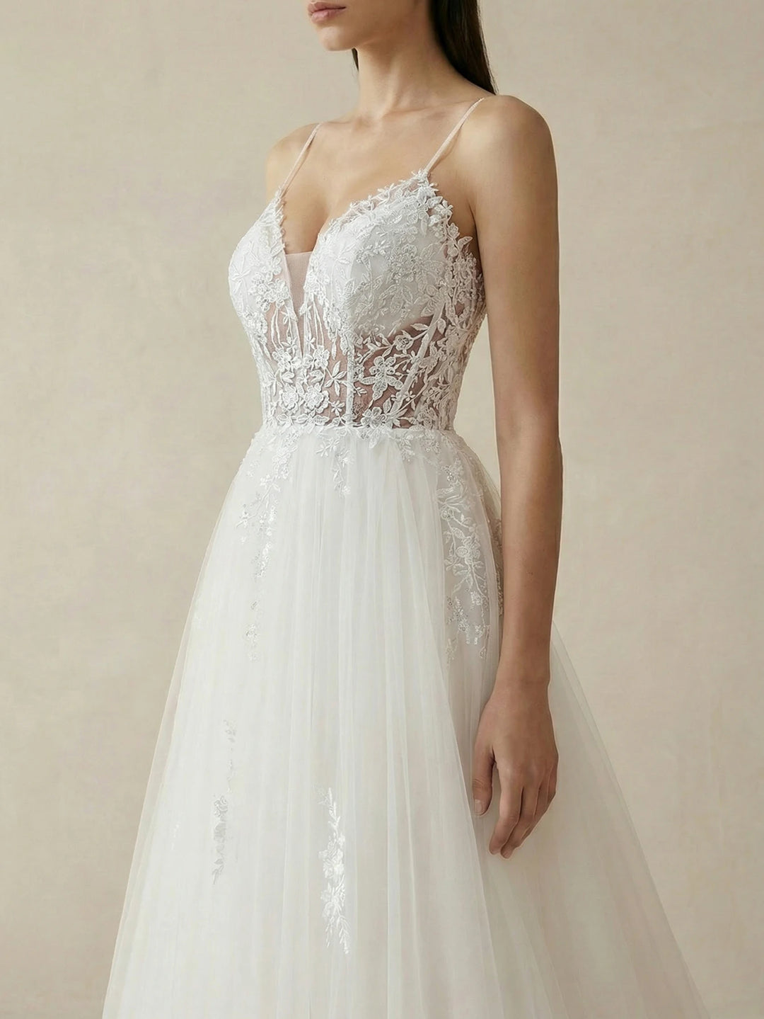 White lace bodice bridal gown with spaghetti straps and deep V neckline