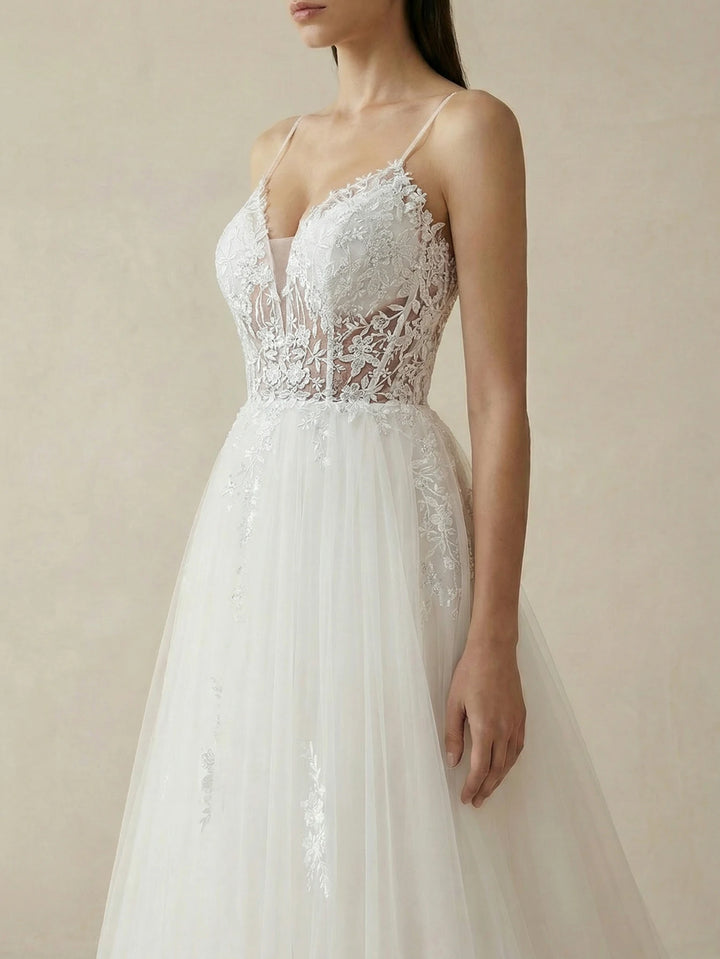 White lace bodice bridal gown with spaghetti straps and deep V neckline