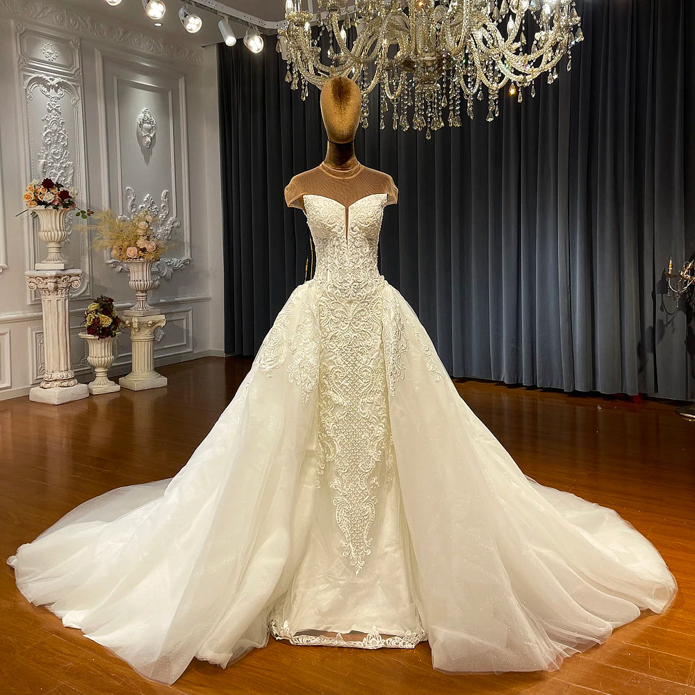 White wedding dress on a mannequin with a chandelier and decorative elements in the background