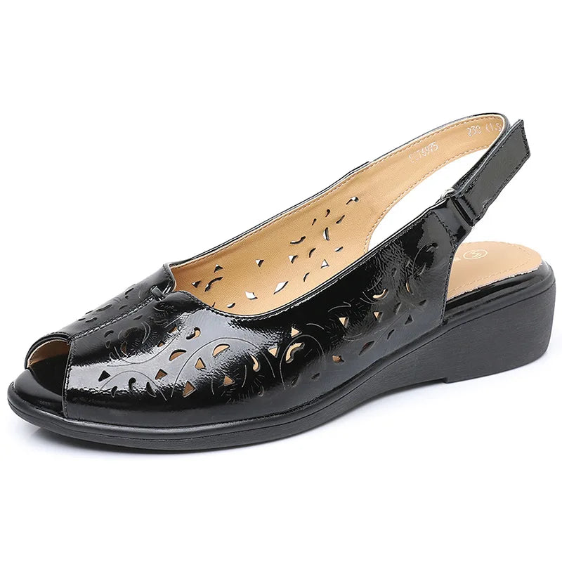 Black open-toe slingback wedge sandal with perforated patent-style leather upper