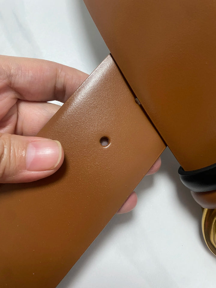 Tan-brown wide leather belt end with stitch edge, round holes, and black backing strap