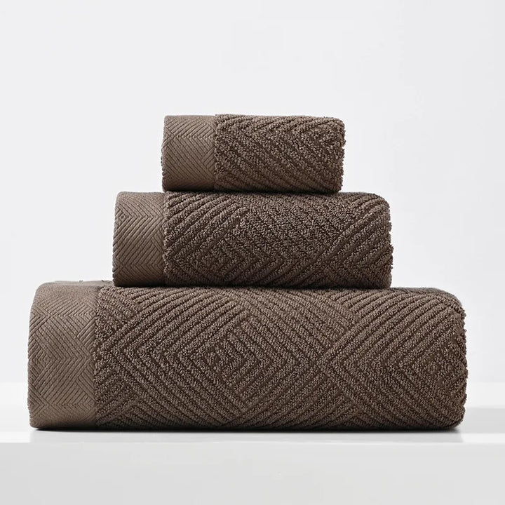 Brown cotton towel set with thick chevron weave, stacked folded towels