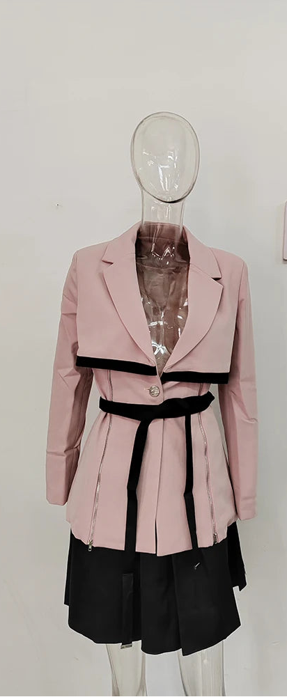 Pink women's cropped skirt suit with black belt and layered skirt