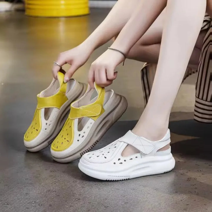 Yellow and white thick-sole leather sandals with hook-and-loop straps, close-up pair
