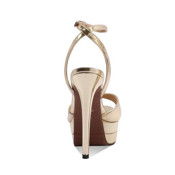 Gold patent platform heeled sandals with open toe and ankle strap, back view