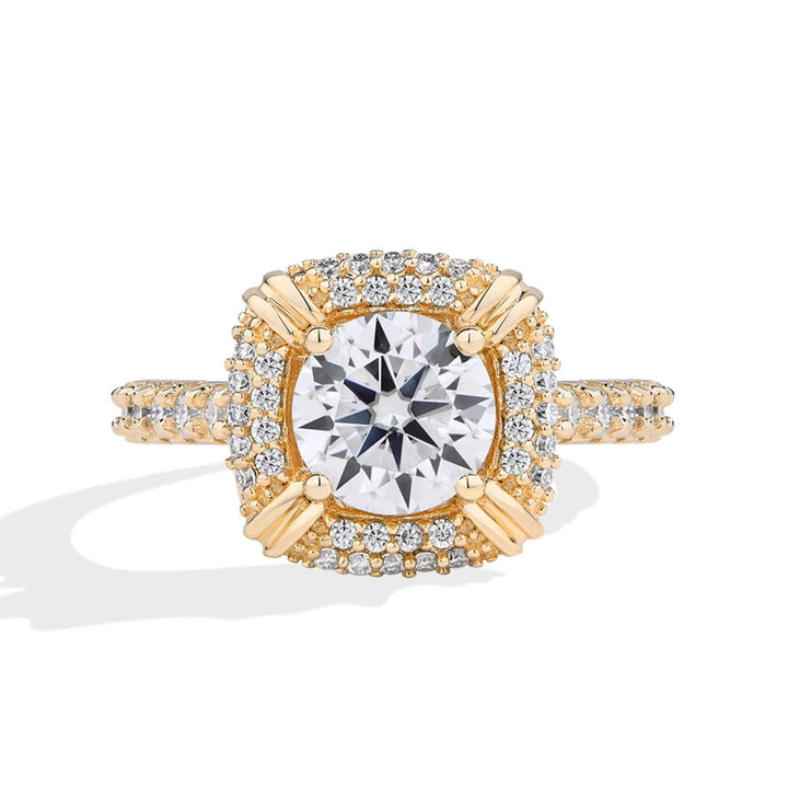 Gold ring with a large diamond and smaller diamonds on a white background, branded 'Minty Box'.