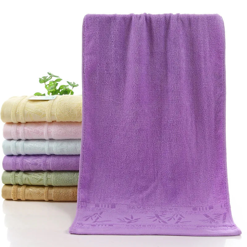 Bamboo bath towel set: purple towel with decorative stitched hem and rolled towels