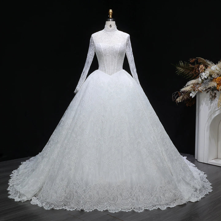 White lace A-line wedding gown with high neckline and long sleeves