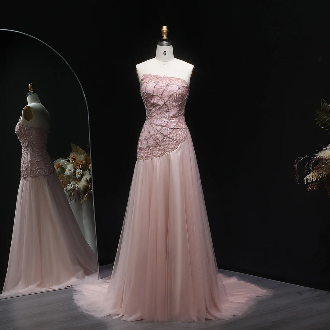 Pink evening gown on a mannequin against a black background