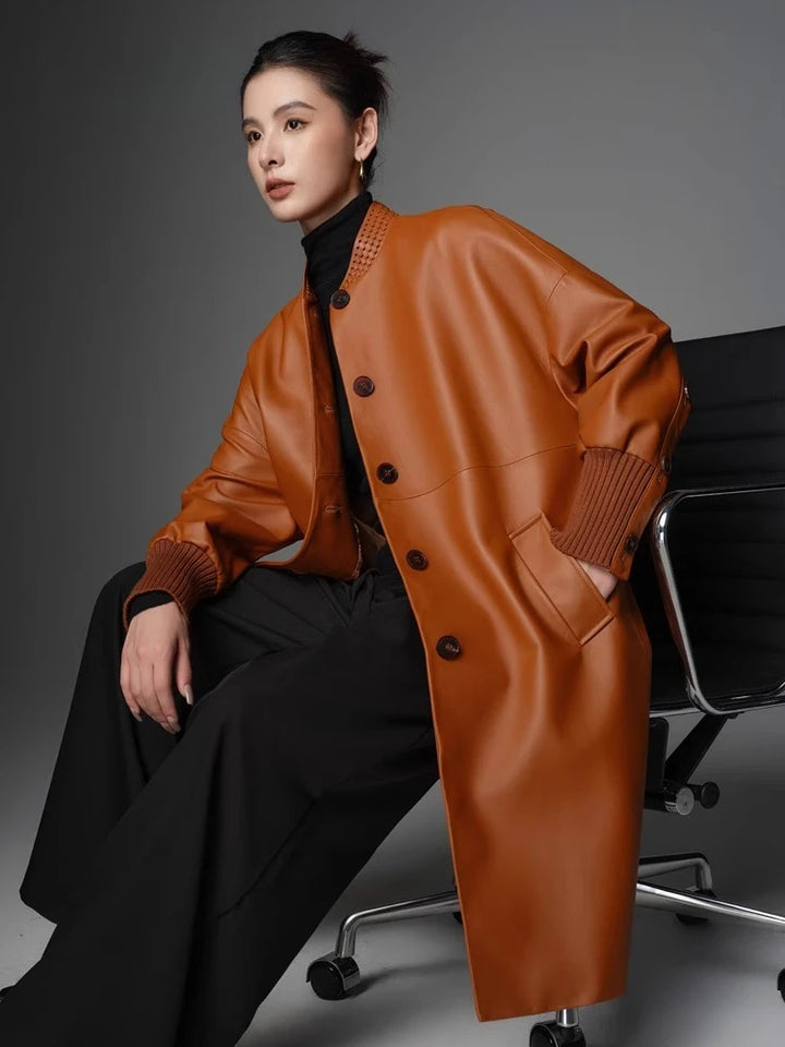 Women’s orange woven coat with stand collar and button front, ribbed knit cuffs, side seam pockets