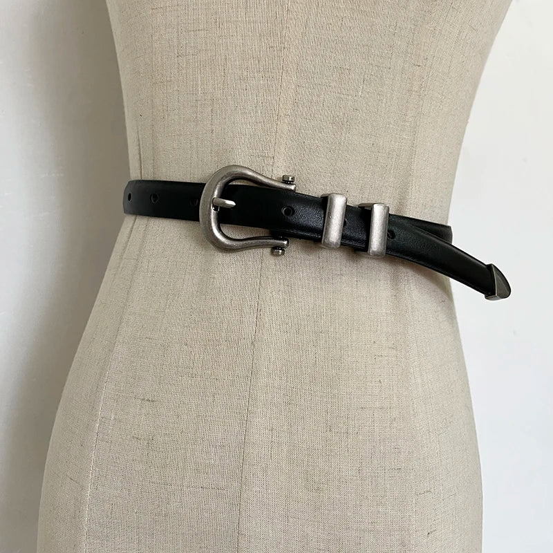 Black narrow leather corset belt with silver-tone oval buckle and two rectangular tabs