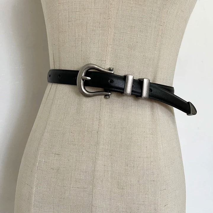 Black narrow leather corset belt with silver-tone oval buckle and two rectangular tabs