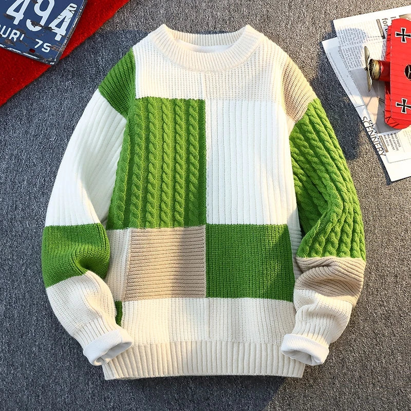 Patchwork knit sweater with green and cream blocks; ribbed crew neck, cuffs, and hem.