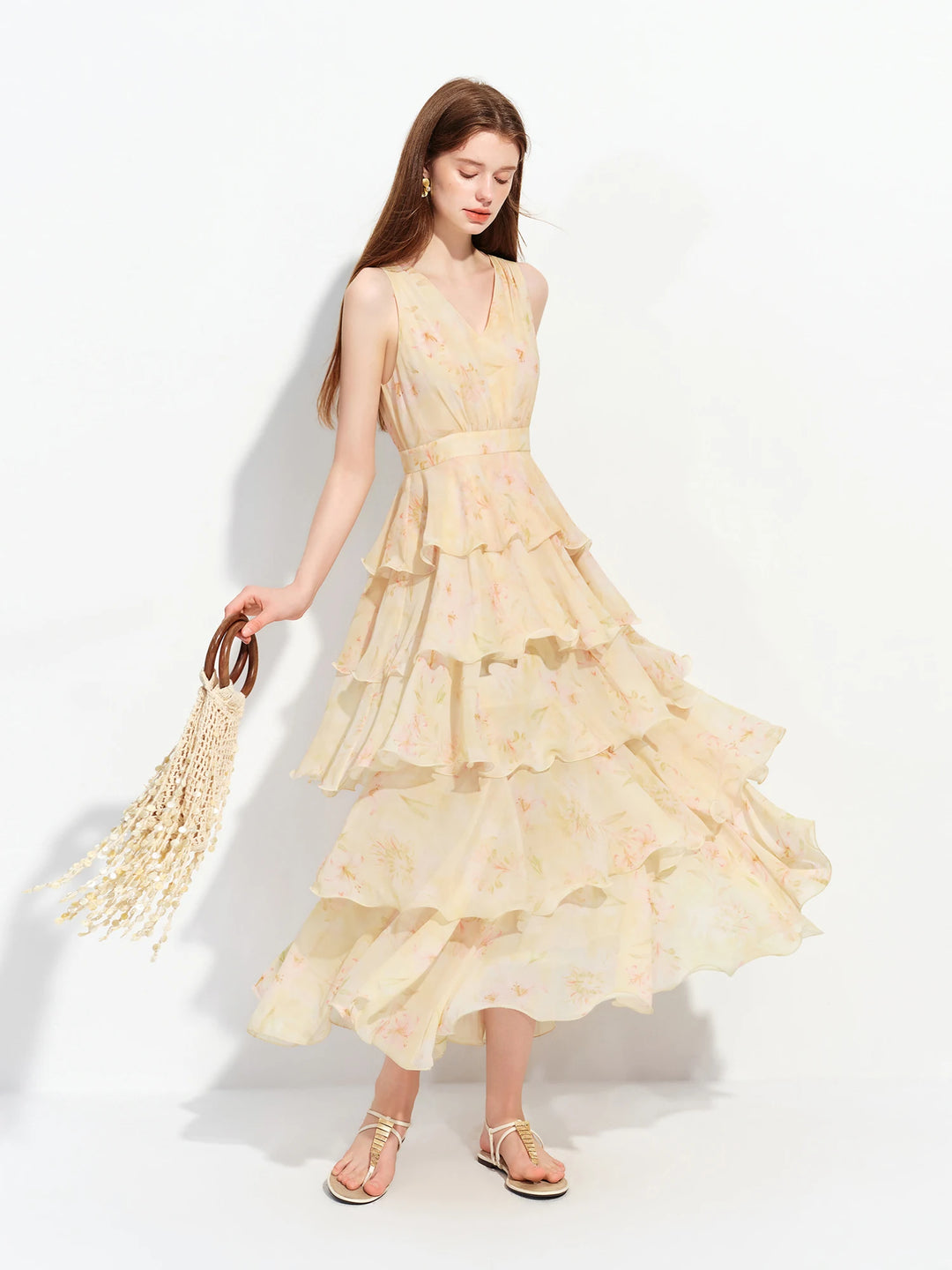 Light yellow tiered ruffle maxi dress with sleeveless bodice and flowing tiered skirt
