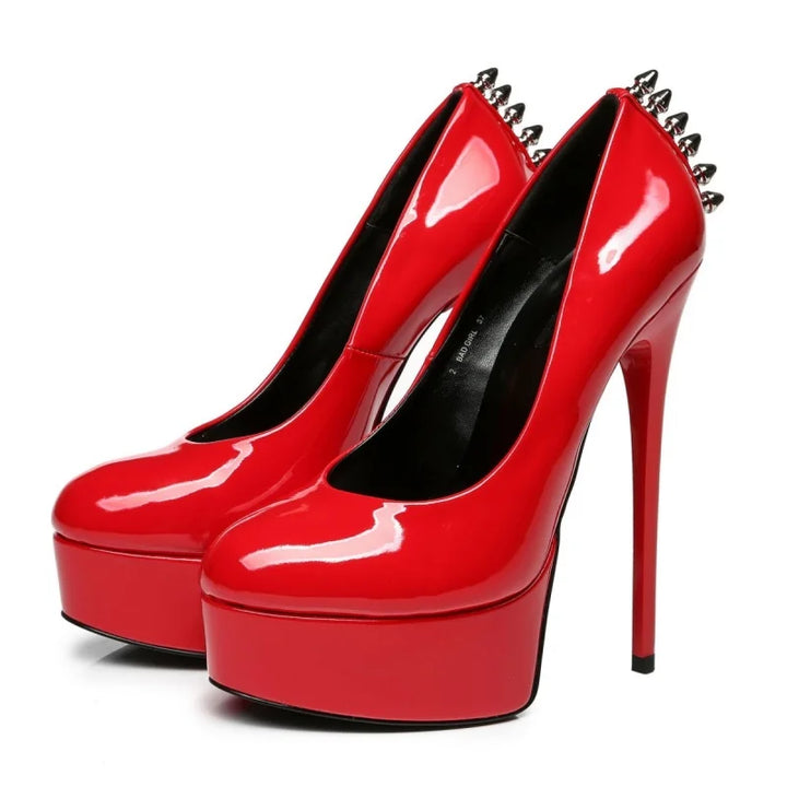 Red patent leather platform rivet heel pumps, pair view with pointed toes and spike rivets