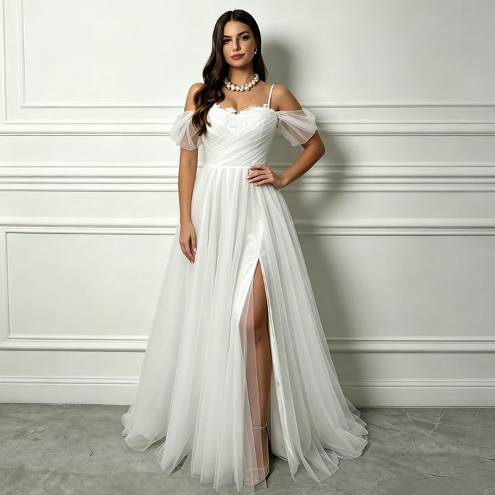 White A-line tulle bridal gown with off-shoulder sleeves and front thigh slit