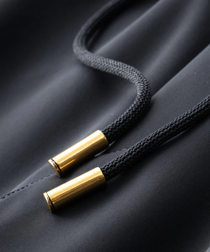 Navy hoodie drawstring ends with gold aglets and textured cord