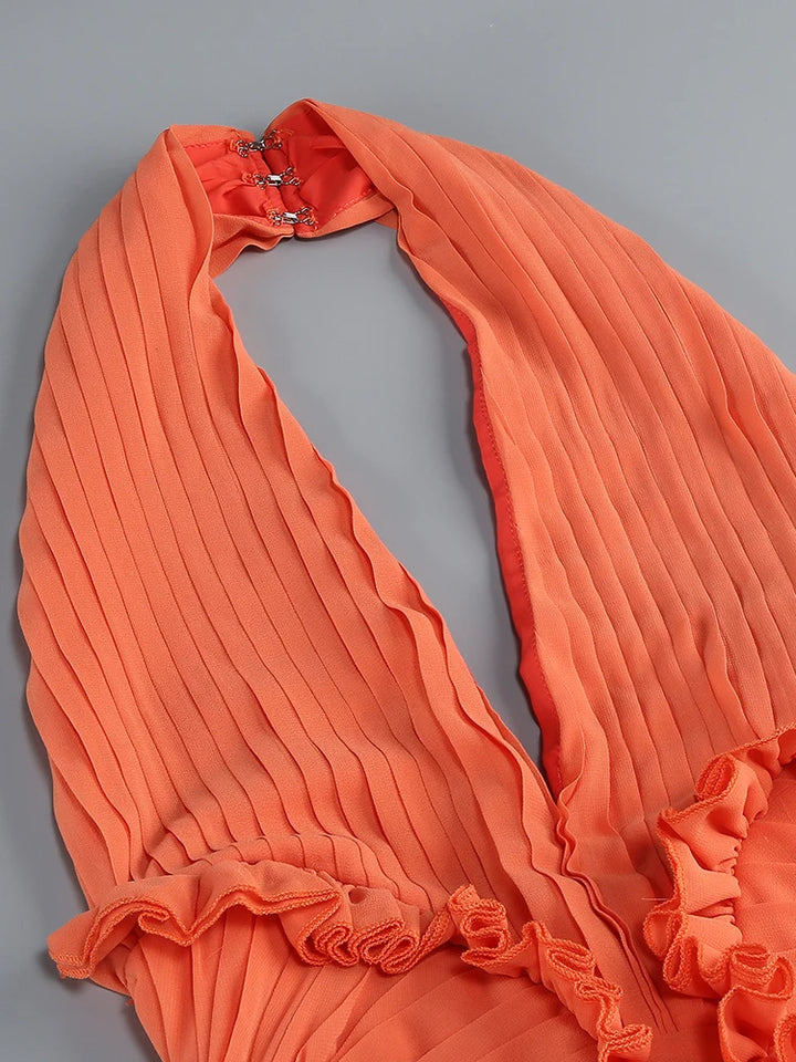 Orange halter dress close-up showing pleated ruffle neckline