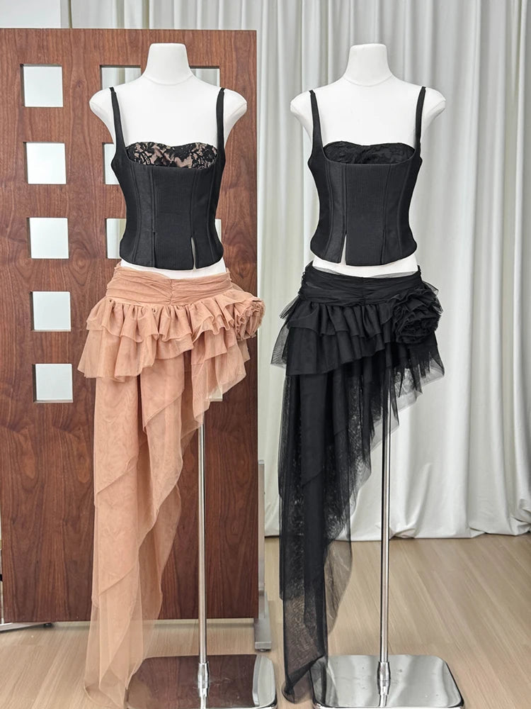Black and tan corset top and asymmetrical ruffled tulle skirt sets on mannequins