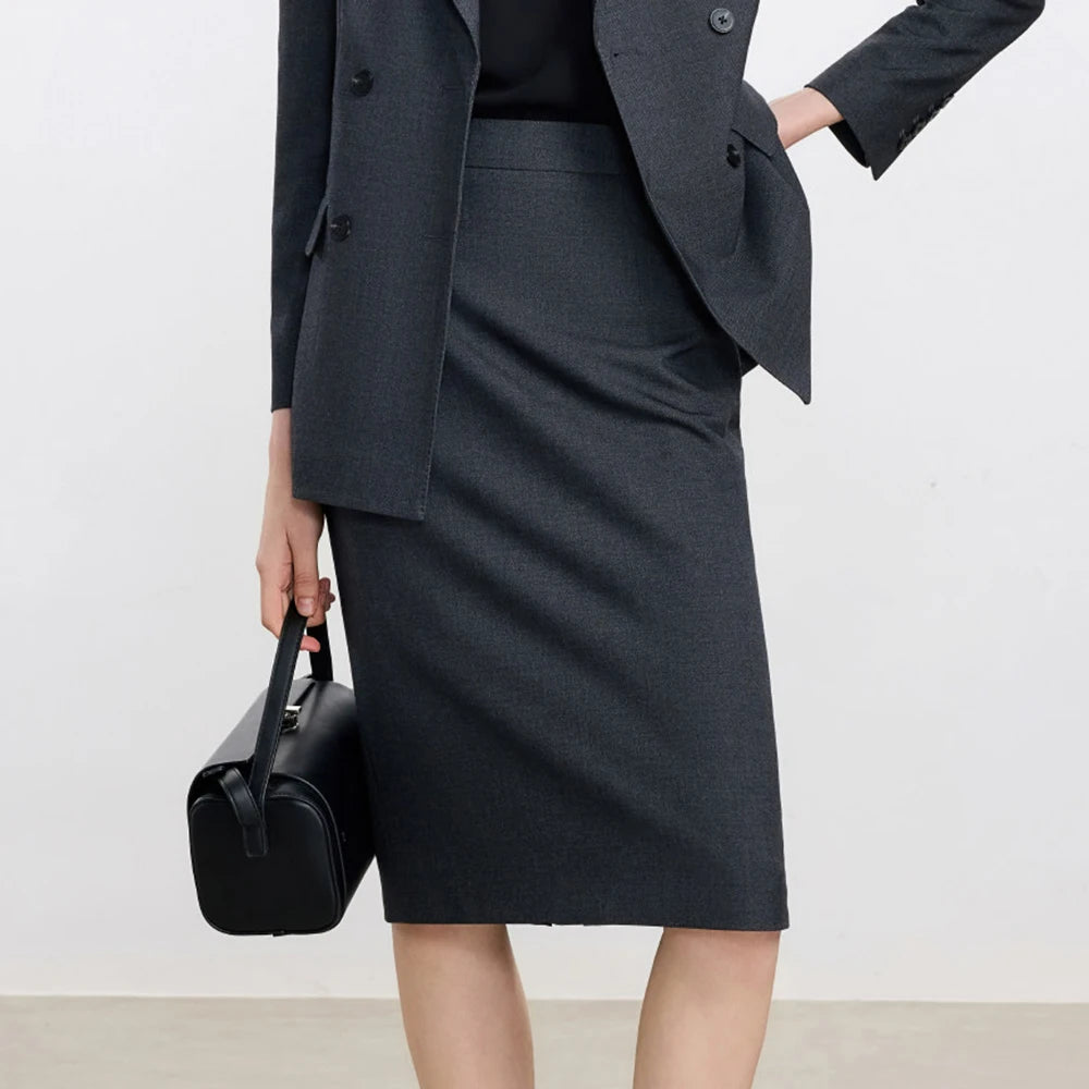 Dark gray pencil skirt with side drape and matching blazer hem, close-up