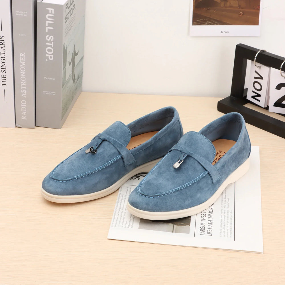 Blue suede slip-on loafers with metal bit detail and white rubber sole