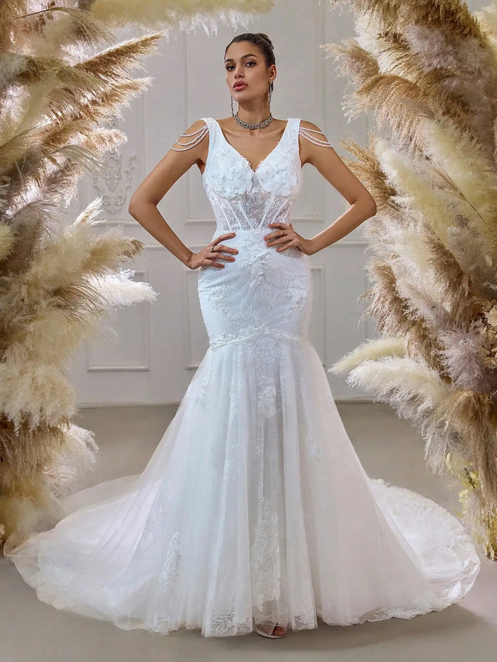 White beaded bridal mesh mermaid gown with illusion neckline and long draped skirt