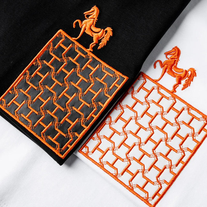 Men’s black and white tee set with orange horse and lattice embroidery accents