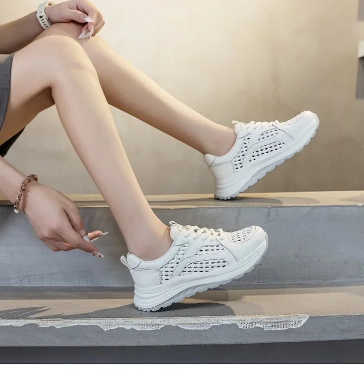 White lace-up woven mesh sneakers with perforated side panels and cushioned outsole.